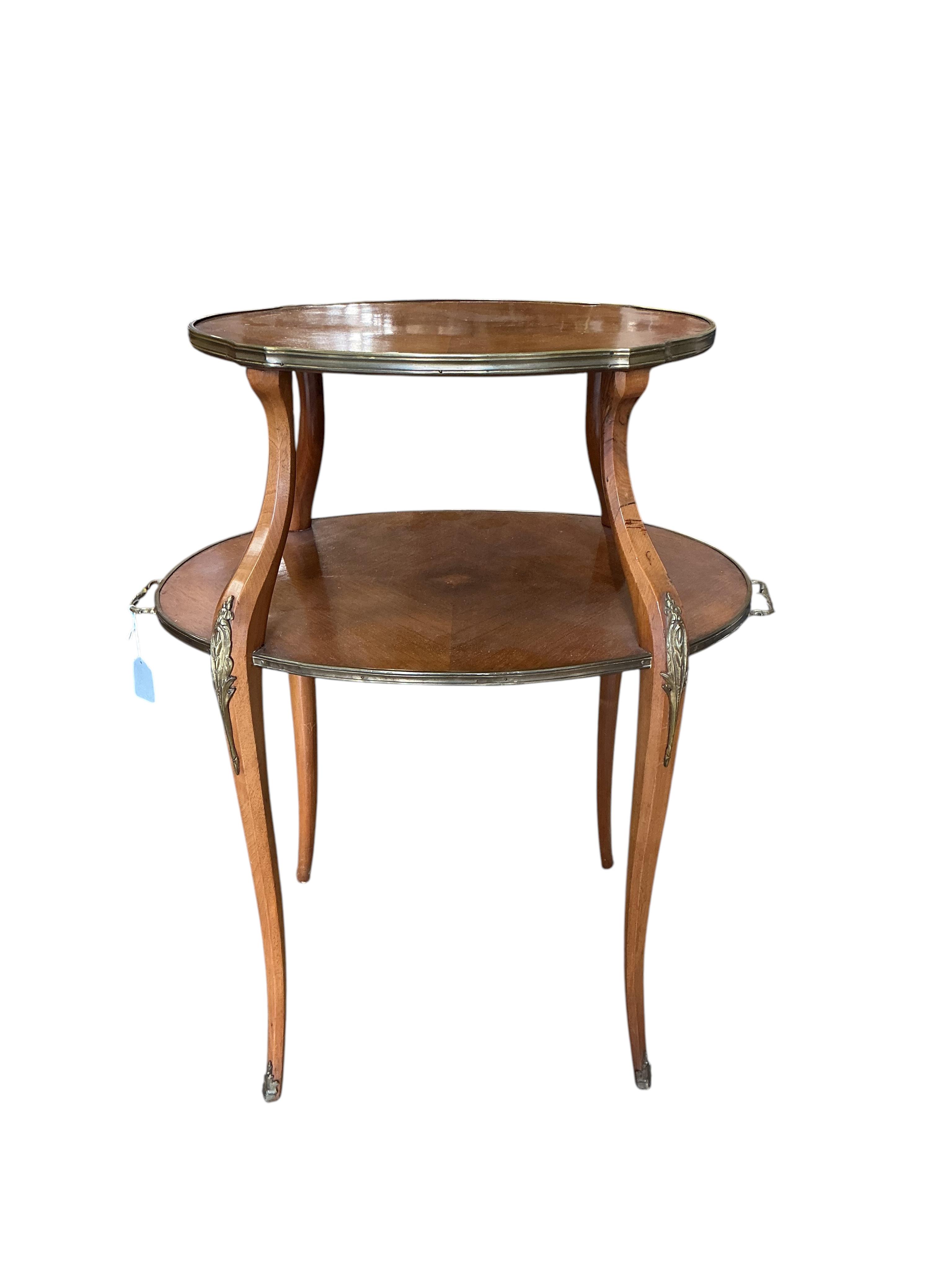 A gilt metal mounted oval mahogany two tier etagere, width 72cm, depth 46cm, height 88cm.